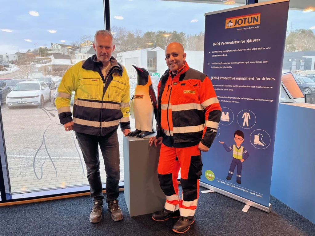 Meeting engineers at Jotun headquarters beside the Jotun penguin statue in Sandefjord Norway